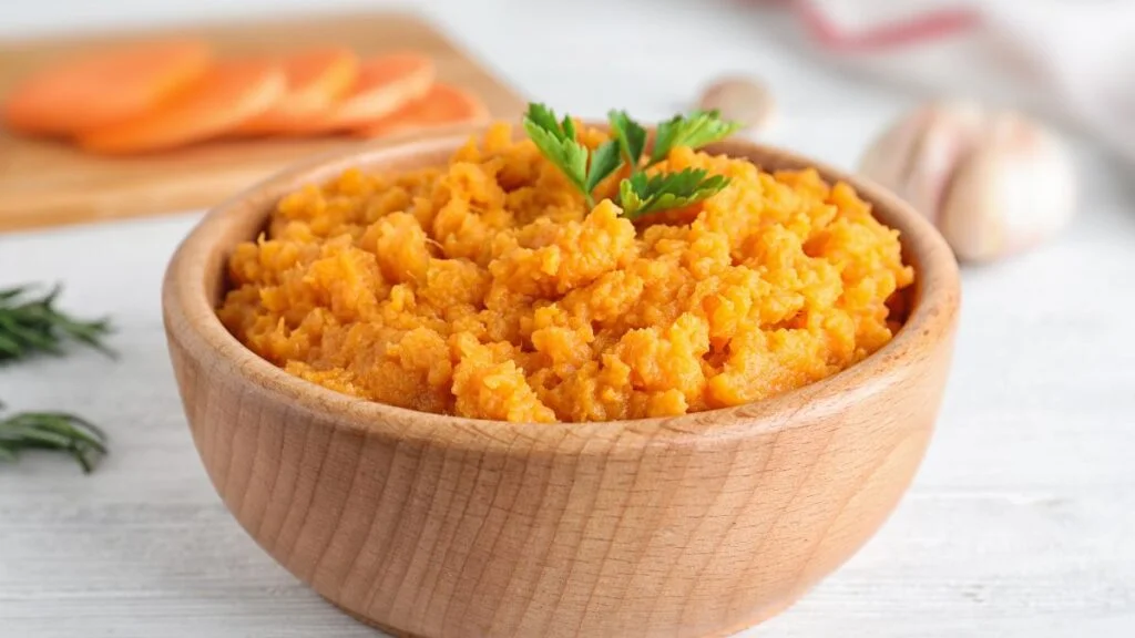 Bowl with Mashed Sweet Potatoes on Wooden Table